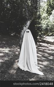 human ghost costume near tree forest