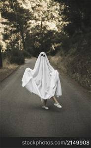 human ghost suit posing countryside route