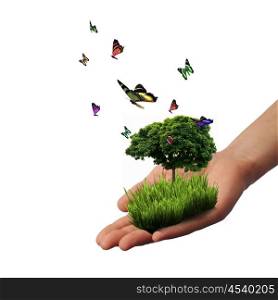 Human hand and multicolored butterflies, grass and a symbol of the environment. Collage.