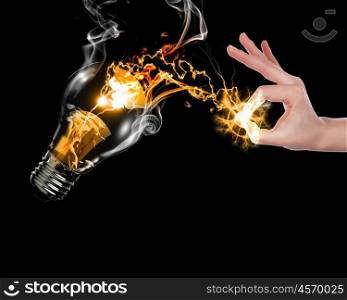human hand, electric charge and light bulb