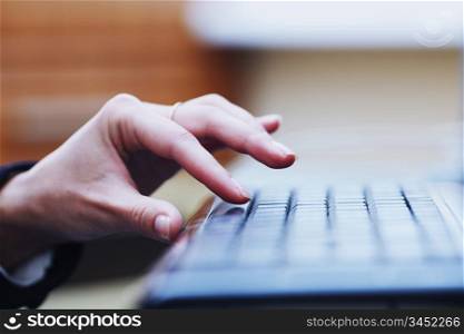 human hand going to press key on keyboard