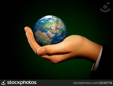 Human hand holding a globe.