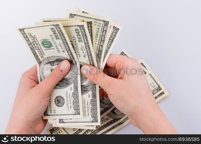 Human hand holding American dollar bill as money isolated on white