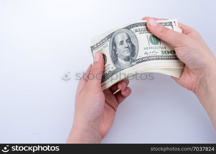 Human hand holding American dollar bill as money isolated on white