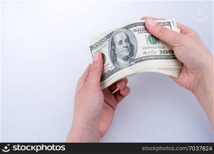 Human hand holding American dollar bill as money isolated on white