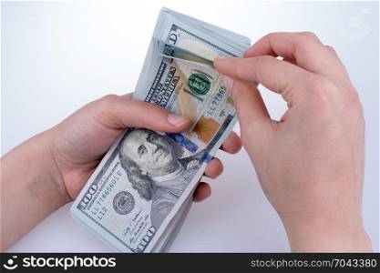 Human hand holding American dollar bill as money isolated on white