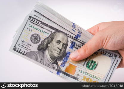 Human hand holding American dollar bill as money isolated on white