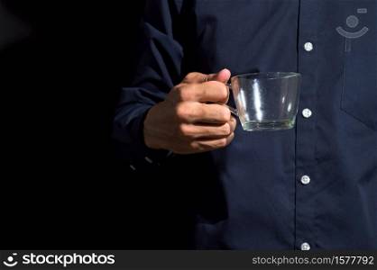 Human hand holding an empty glass