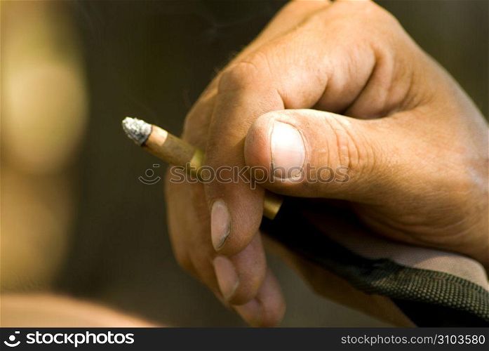 Human hand holding cigarette