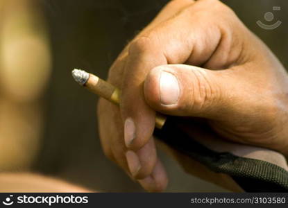 Human hand holding cigarette