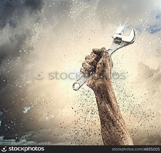 Human hand holding. Close-up image of human hand holding wrench. Construction