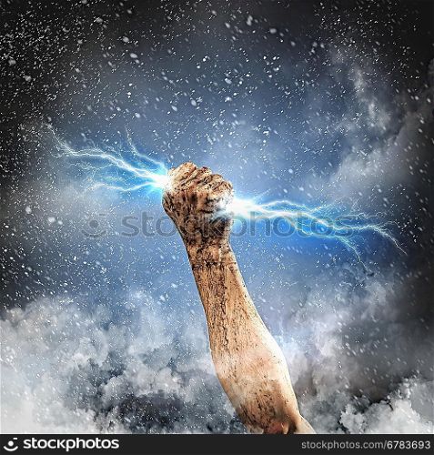 Human hand holding lightning