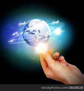 Human hand holding our planet earth glowing