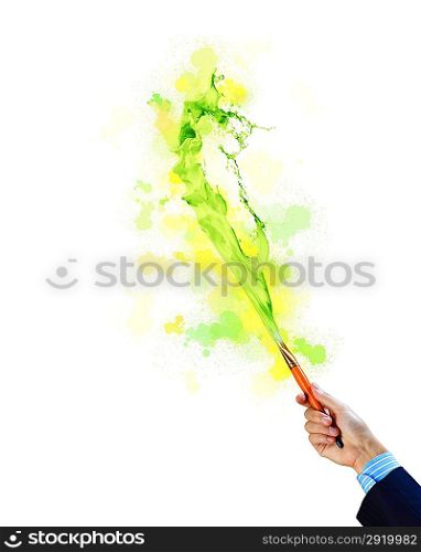 Human hand holding paint brush