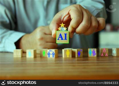 human hand holding wood block with ai letter .icon people on wood cube on wood floor