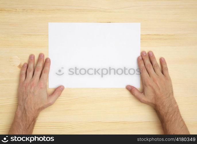 human hand holds a blank paper