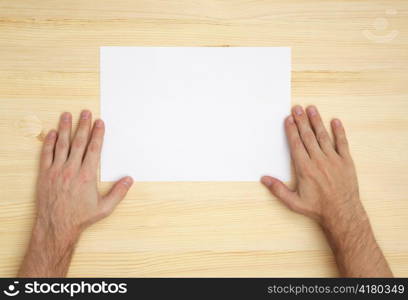 human hand holds a blank paper