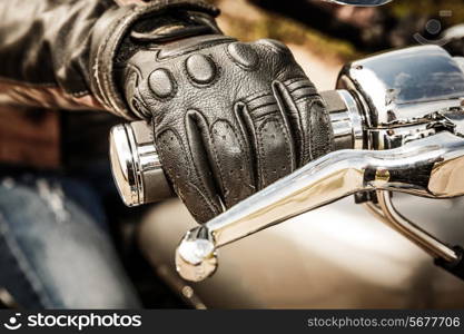 Human hand in a Motorcycle Racing Gloves holds a motorcycle throttle control. Hand protection from falls and accidents.