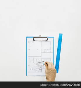 human hand making blueprint using rounder white desk