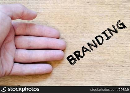 Human hand over wooden background and branding text concept
