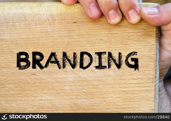 Human hand over wooden background and branding text concept