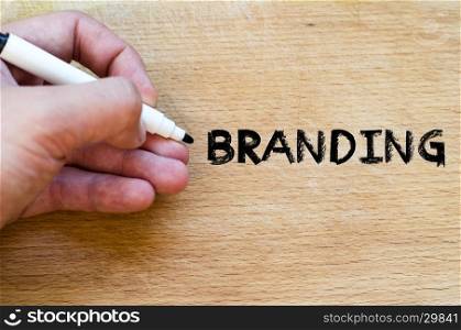 Human hand over wooden background and branding text concept