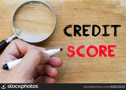 Human hand over wooden background and credit score text concept