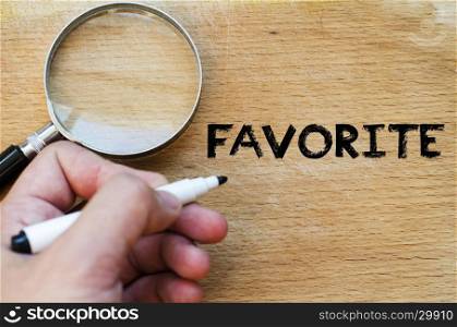 Human hand over wooden background and favorite text concept