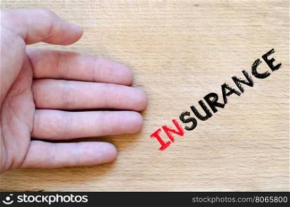 Human hand over wooden background and insurance text concept
