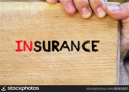 Human hand over wooden background and insurance text concept