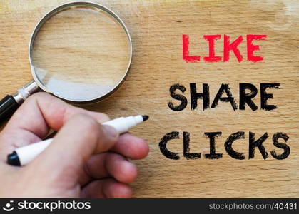 Human hand over wooden background and like share clicks text concept