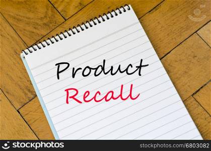 Human hand over wooden background and product recall text concept