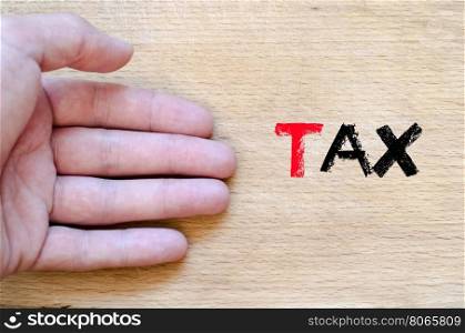 Human hand over wooden background and tax text concept