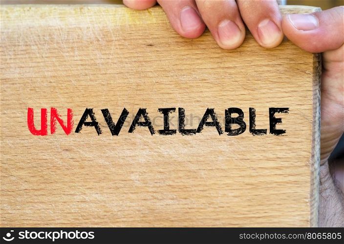 Human hand over wooden background and unavailable text concept