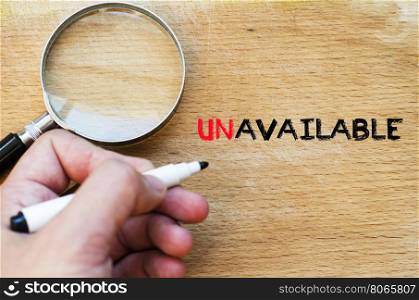Human hand over wooden background and unavailable text concept