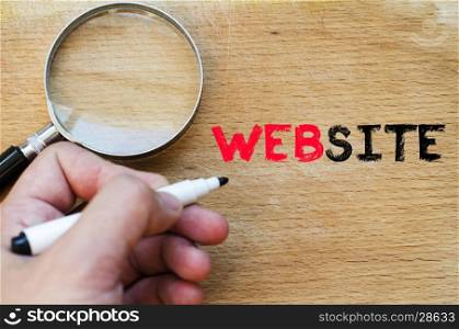 Human hand over wooden background and website text concept