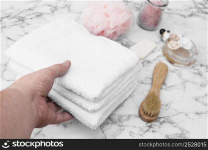 human hand picking stack towels