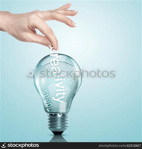 Human hand putting word Information inside a light bulb