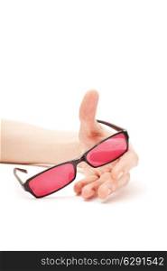 Human hand with pink glasses isolated on white background