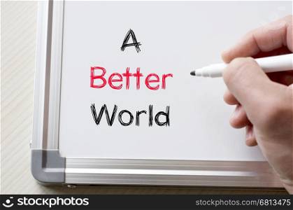 Human hand writing a better world on whiteboard