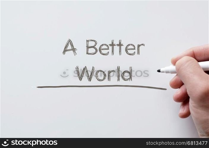 Human hand writing a better world on whiteboard