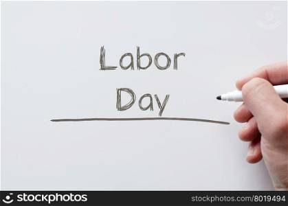 Human hand writing labor day on whiteboard