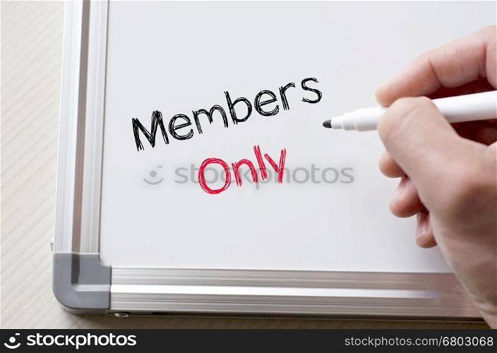 Human hand writing members only on whiteboard