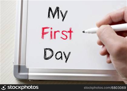 Human hand writing my first day on whiteboard