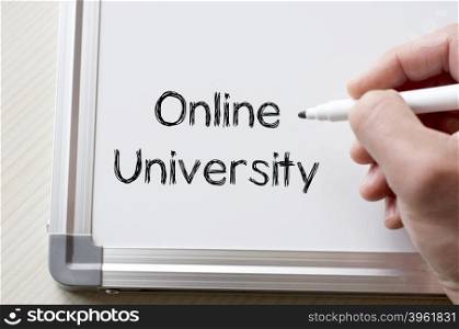 Human hand writing online university on whiteboard