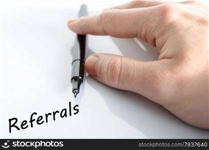 Human hand writing Referrals isolated over white background - business concept