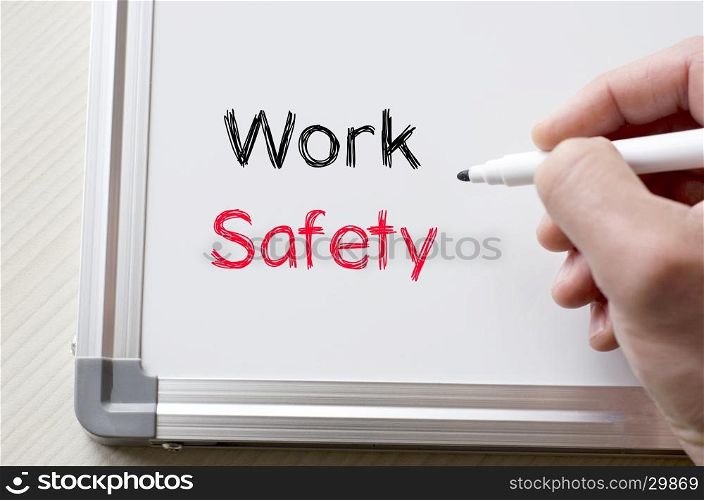 Human hand writing work safety on whiteboard