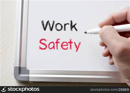 Human hand writing work safety on whiteboard
