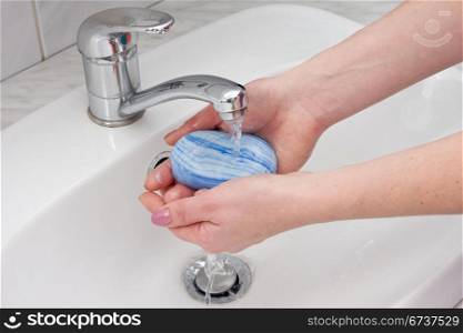 human hands being washed under stream of pure water