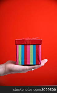 Human hands holding gift box, close-up
